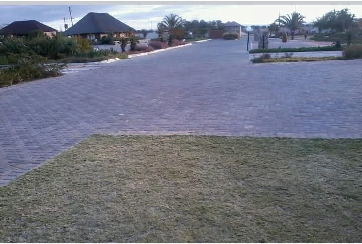Wide paved driveway leading to main buildings