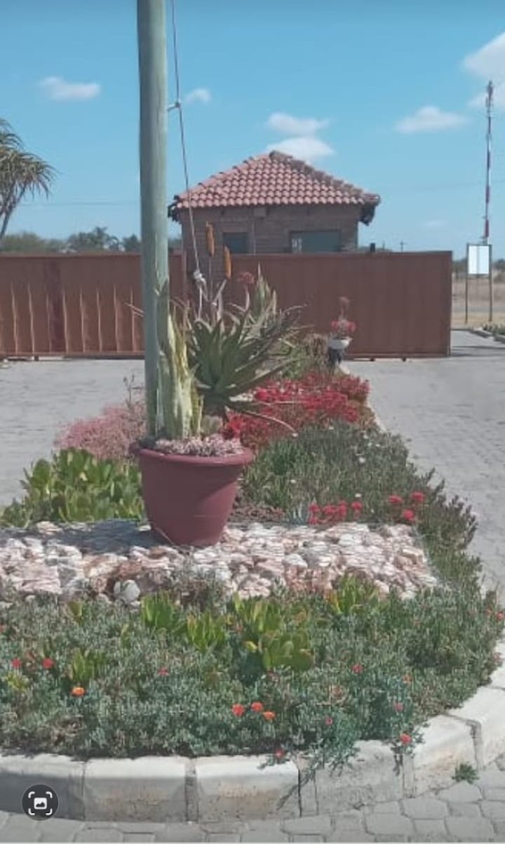 Main security gate with landscaped entrance