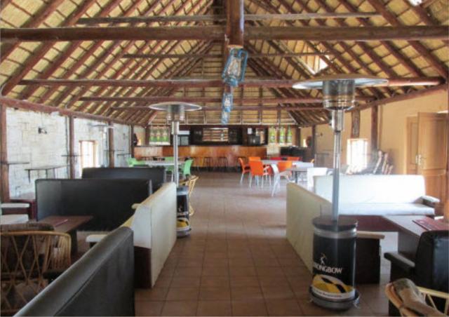 Indoor lounge with thatch roof and comfortable seating