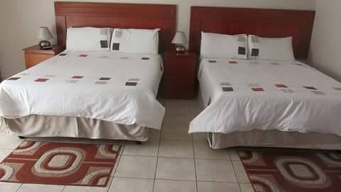 Twin beds with matching linens and bedside tables